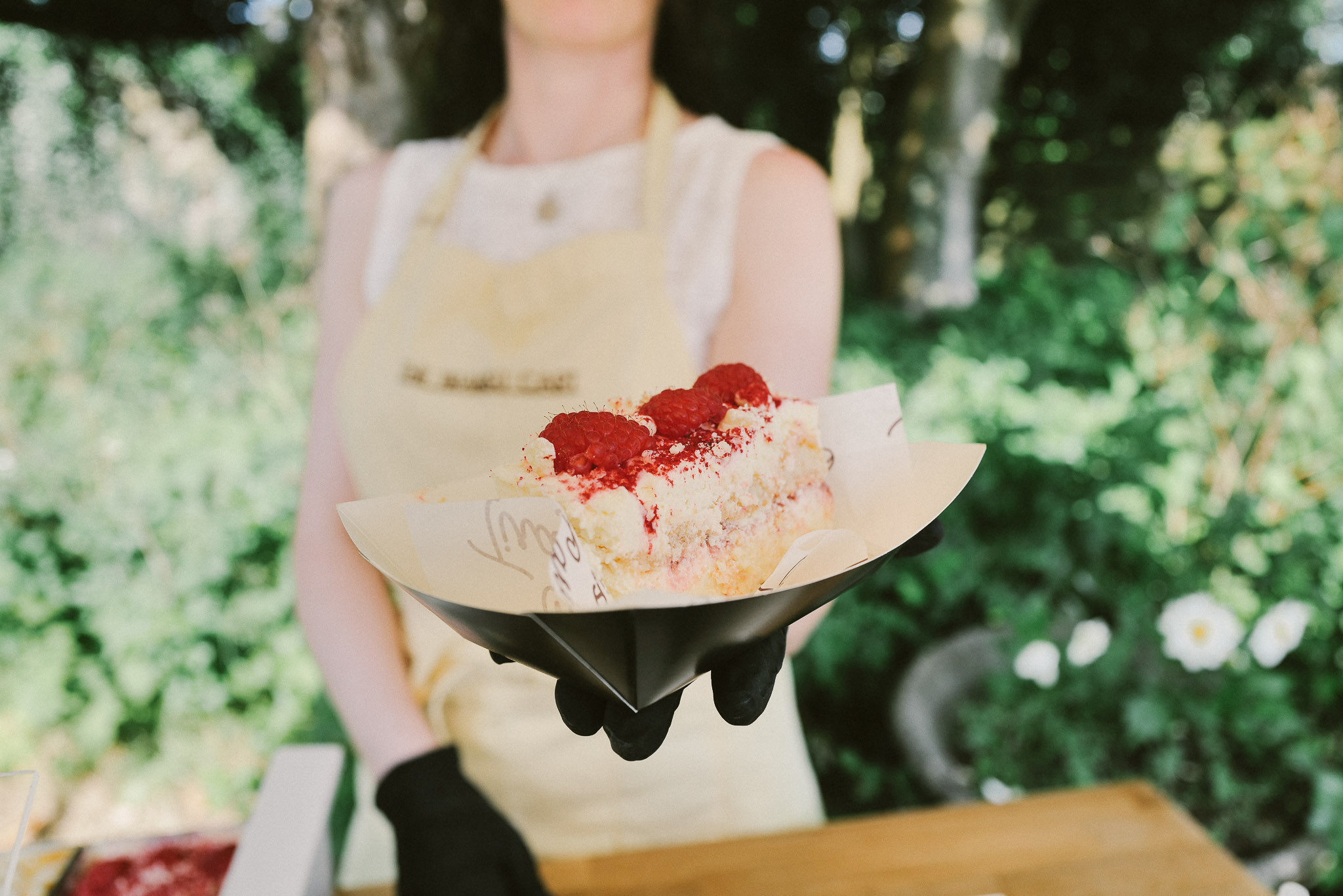 A generous slice of tiramisu being lifted from the tray and served